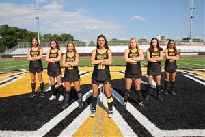 cb west field hockey team seniors stand in formation on the field