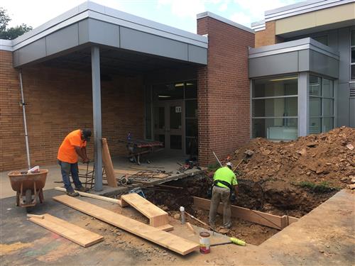 workers digging a walkway 