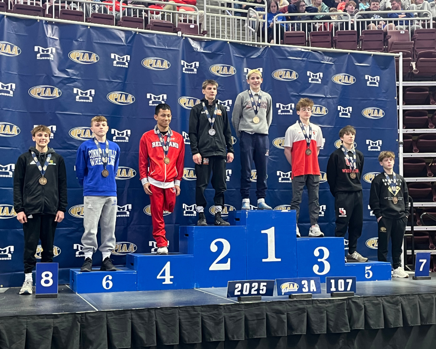 Chase Williams on a podium in the first position among 7 other competitors.