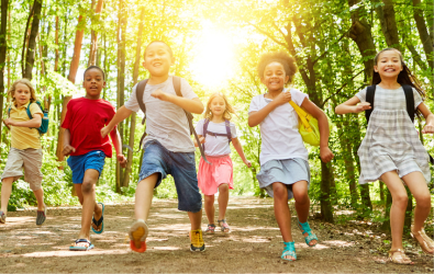 Kids running outside in the woods.