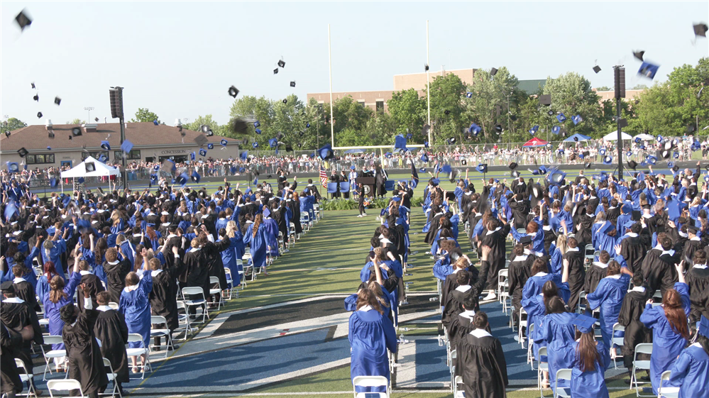 CB South graduates tossing their hats in the air at CB South graduation ceremony 2025