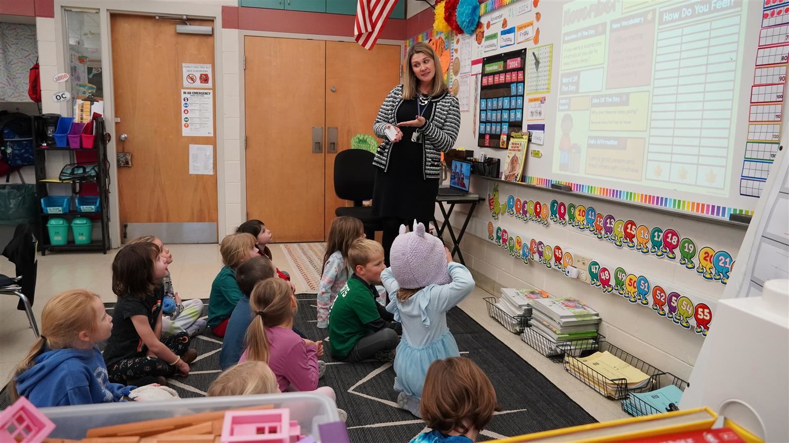 A kindergarten teacher instructs a group of students