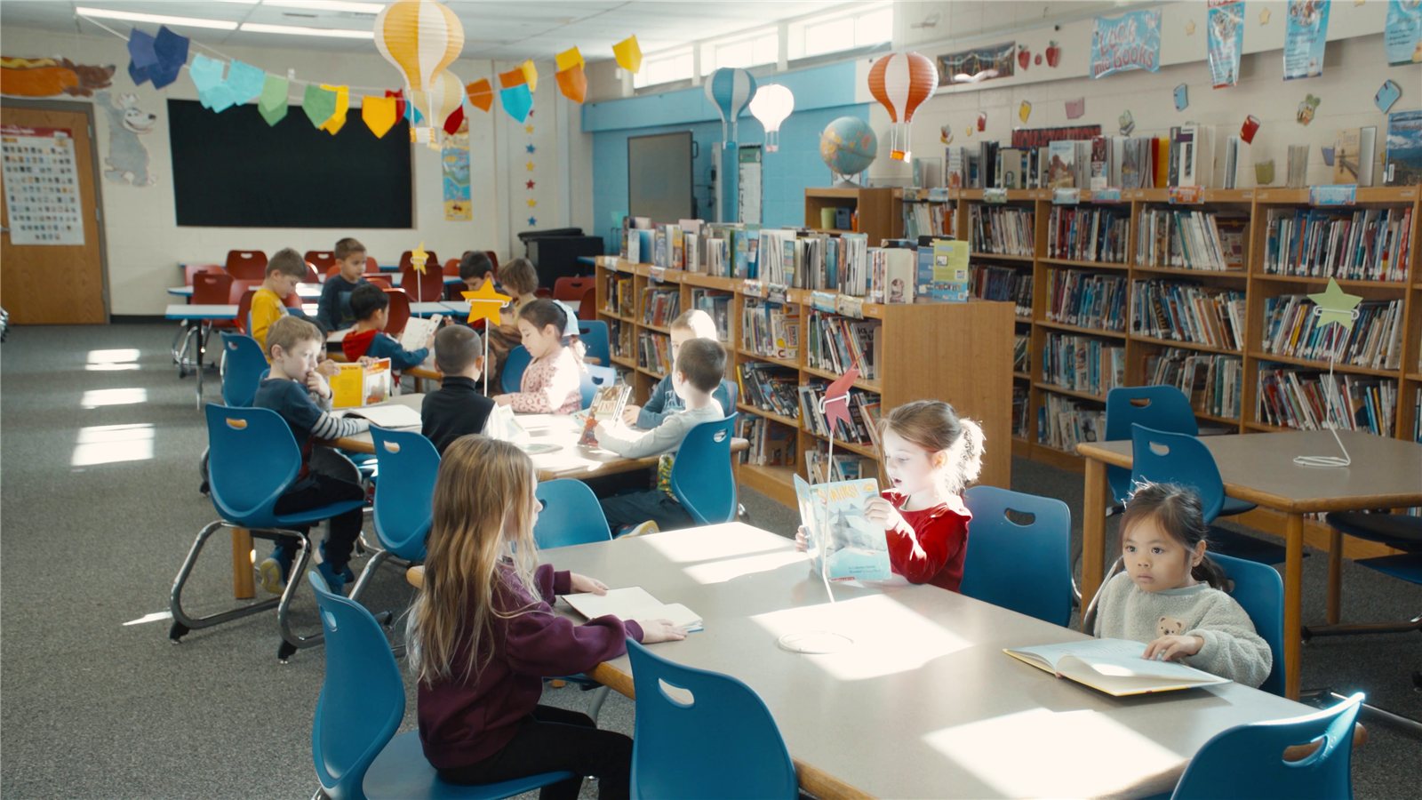 K students read together in a library